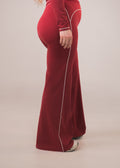 Red velvet outfit with white piping on a beige background