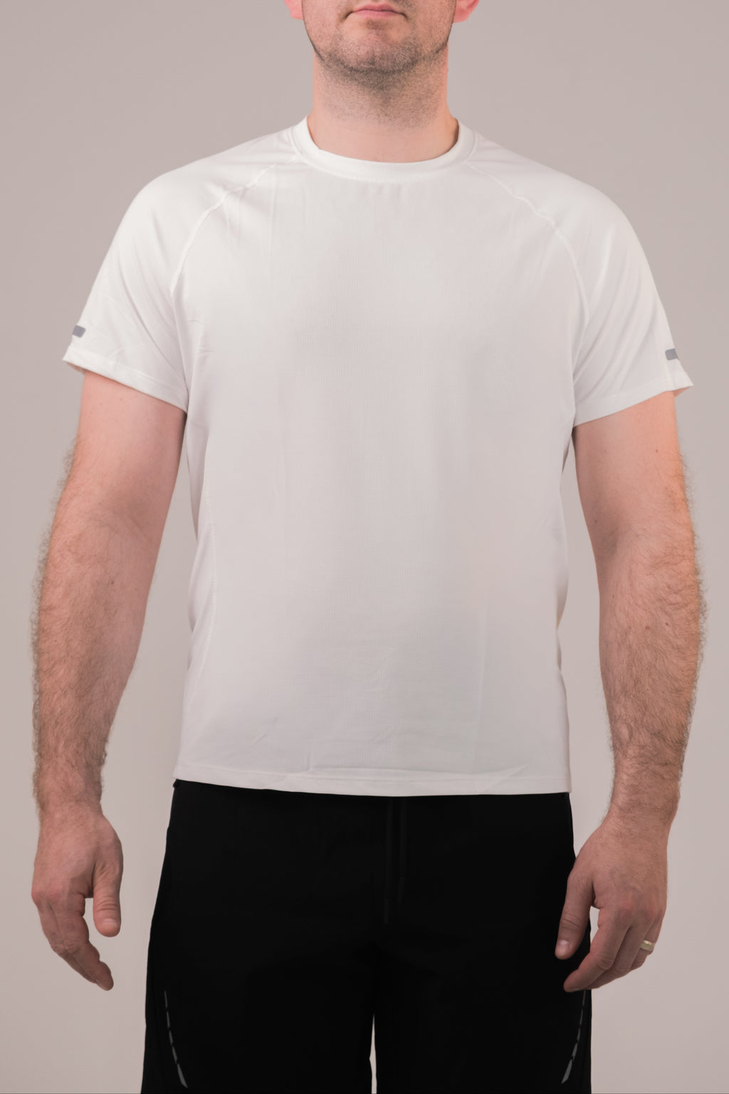 Person wearing a plain white t-shirt against a neutral background