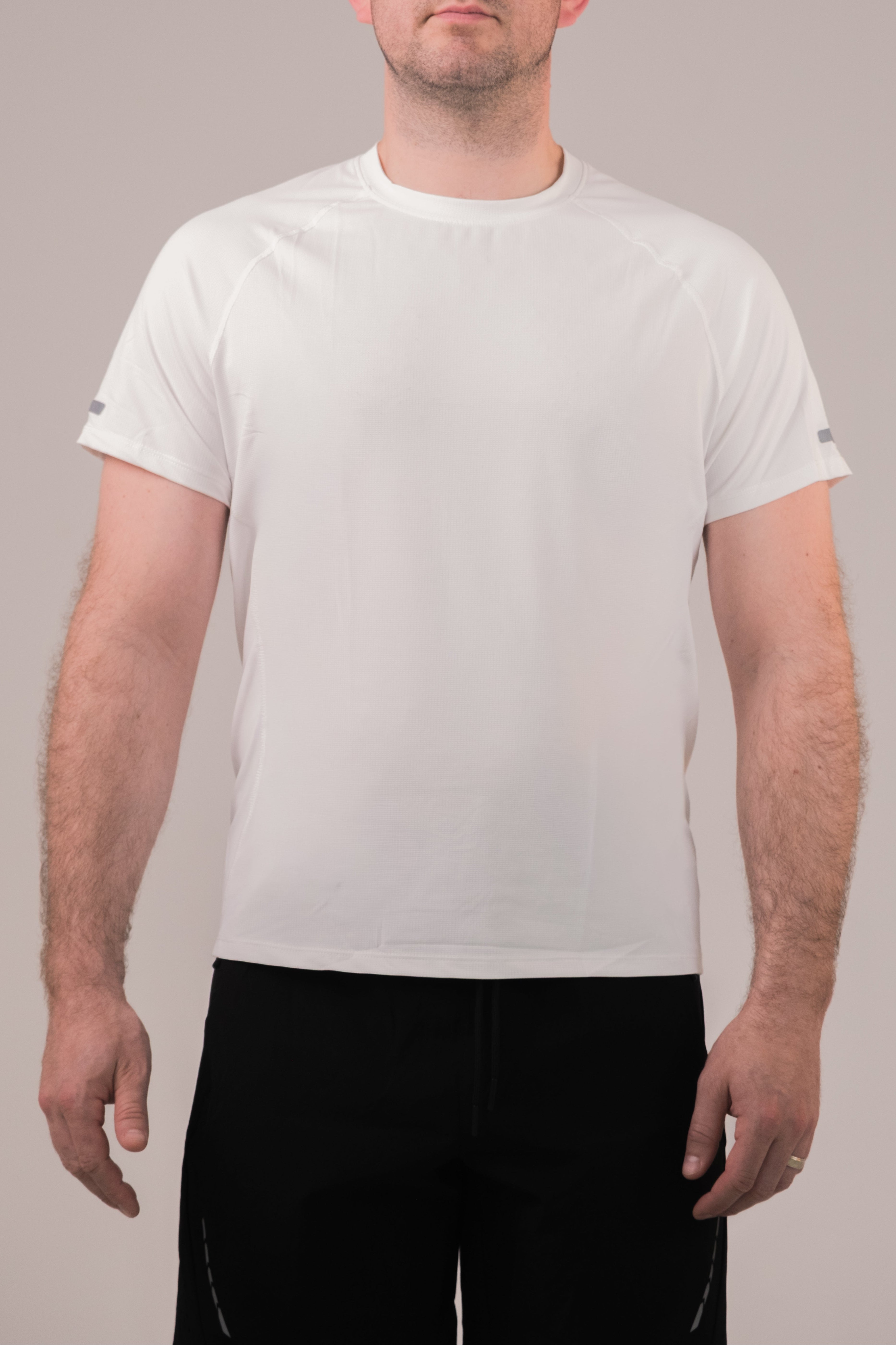 Person wearing a plain white t-shirt against a neutral background