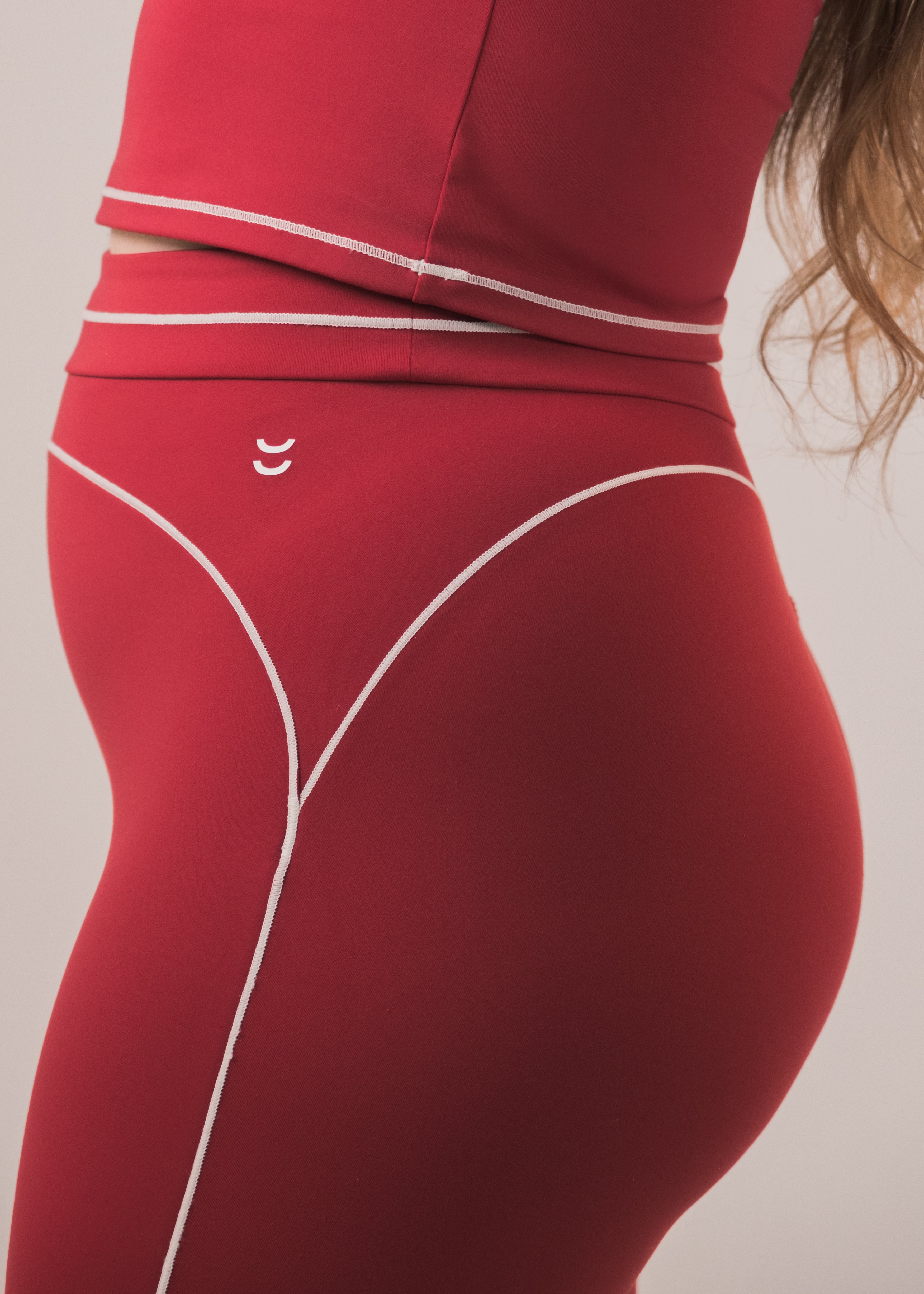 Red leggings with white accents on a plain background
